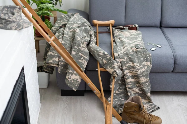 stock image military uniform with crutches. disability.