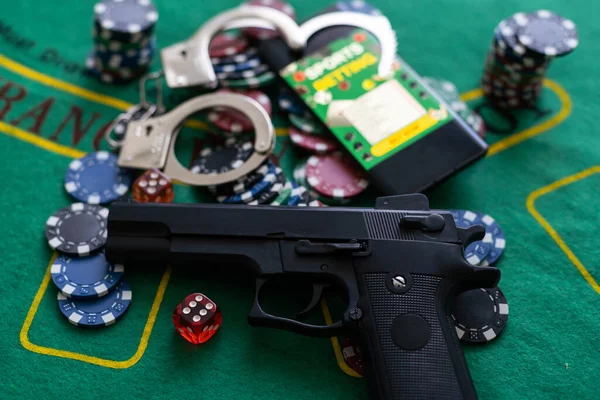 stock image smartphone with sports betting, handcuffs, gun gambling shoot.