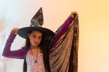 teenage girl in a witch costume, happy halloween holiday