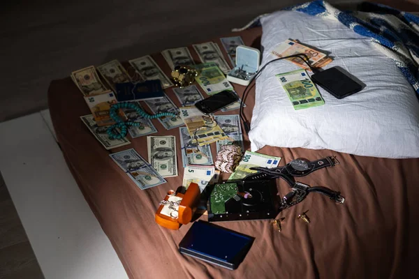 Evidence bag next to dollar banknotes in a crime investigation unit, concept image. High quality photo