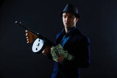 Mature Business Man Holding Gun on a dark background.