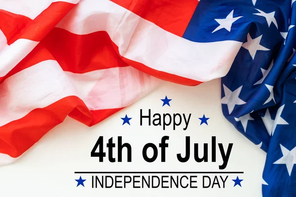 stock image some american flags and the text happy independence day against an off-white background. High quality photo