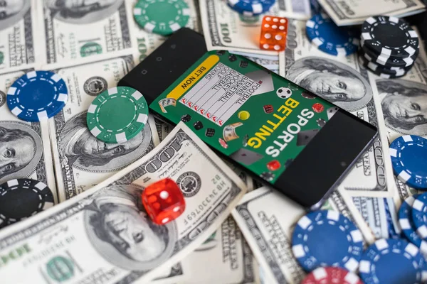 money and smartphone with sports bet application. High quality photo