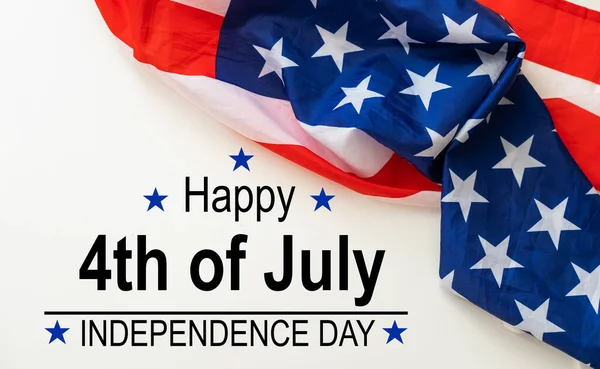stock image some american flags and the text happy independence day against an off-white background. High quality photo