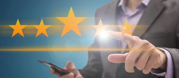stock image Young businessman ranking with his hand using digital stars. High quality photo
