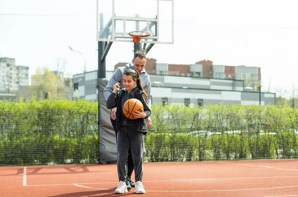 stock image Happy father and teen daughter outside at basketball court