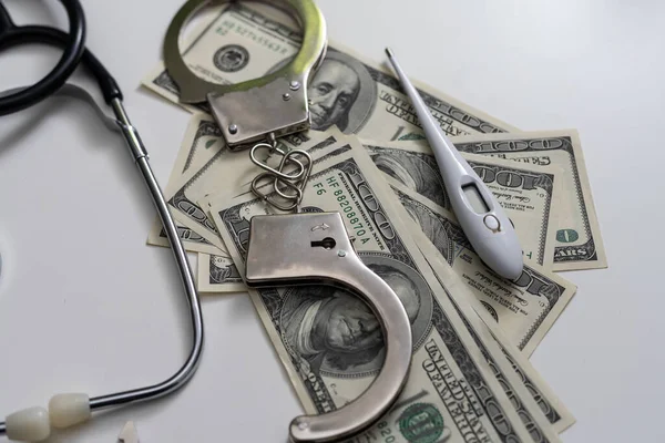 Stethoscope Handcuffs Money Gray Background — Stock Photo, Image