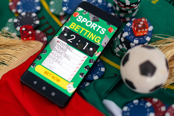 Smartphone and casino chips stacking on a green felt. High quality photo