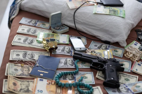 Evidence bag next to dollar banknotes in a crime investigation unit, concept image. High quality photo