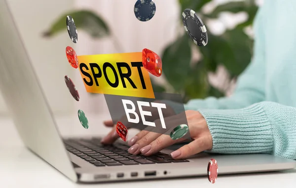 Sports betting concept on laptop computer screen on wooden table. Hands typing on a keyboard. All screen content is designed by me. . High quality photo