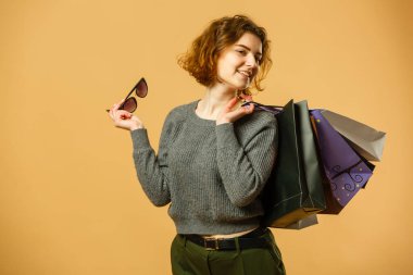 Portrait of happy beautiful shopaholic woman carry shopping bags, advertising concept isolated banner background.