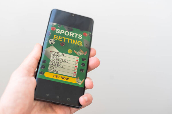 Shot of a man using a mobile phone shows a betting application with live results and updates with white background. Online betting concept. High quality photo