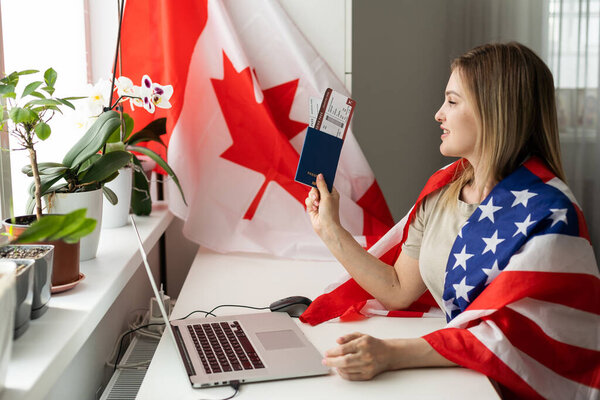Picture of happy young lady with USA flag using laptop computer. Looking camera. High quality photo