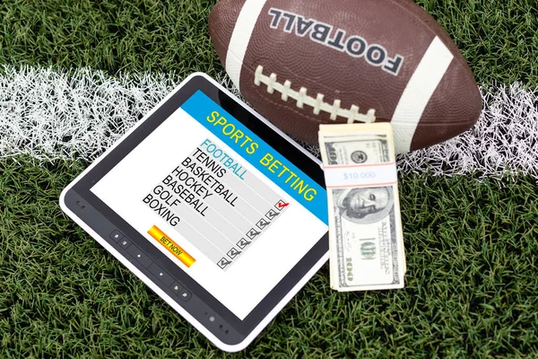 Money, balls and tablet computer on color background. Concept of sports bet. High quality photo