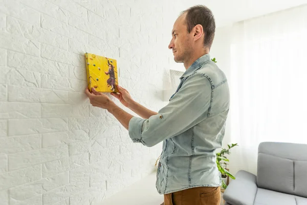 stock image a man is holding a photo canvas. High quality photo