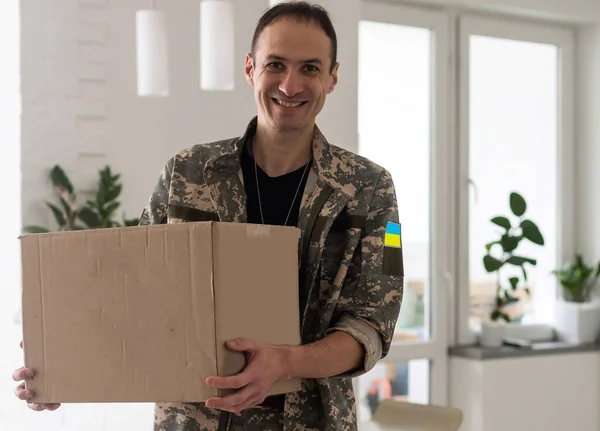 Ukrainian military man with a box.