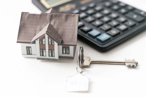 stock image real estate concept, house model with key and money . High quality photo