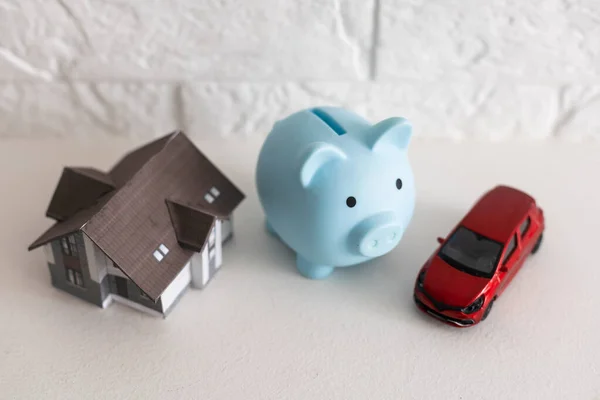 Piggy bank financial savings for house and car. Buying and renting real estate and transport concept. High quality photo