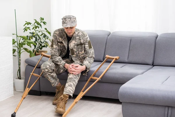 military man with crutches, disability.