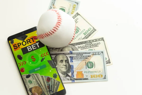 stock image baseball is the ball at the one hundred dollar Banknotes. High quality photo