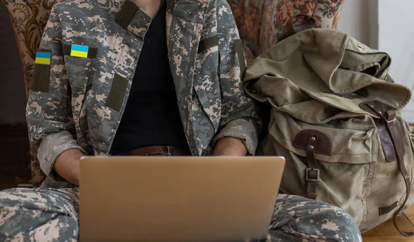 stock image Ukrainian military man with a laptop.