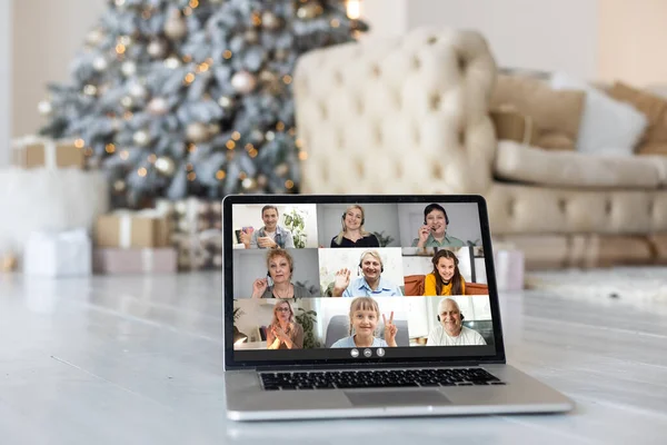 Family video call by remote chat laptop computer screen on Christmas holiday background. Xmas online virtual family party celebration, Happy New Year videocall