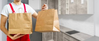 Fast food kutusu teslimatçı tarafından müşterilerden biri için taşınıyor..