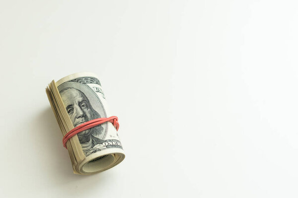 roll of money wrapped with a red elastic isolated. High quality photo