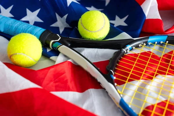 Tennis tournament: racket, balls and American flag, sports and competition concept 3D illustration. High quality photo