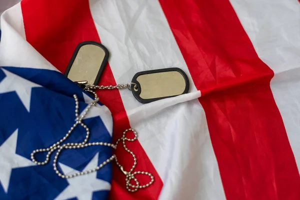 American flag and soldiers tags on background. Veterans Day Concept. High quality photo