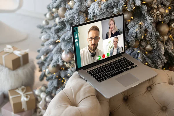 Family video call by remote chat laptop computer screen on Christmas holiday background. Xmas online virtual family party celebration, Happy New Year videocall