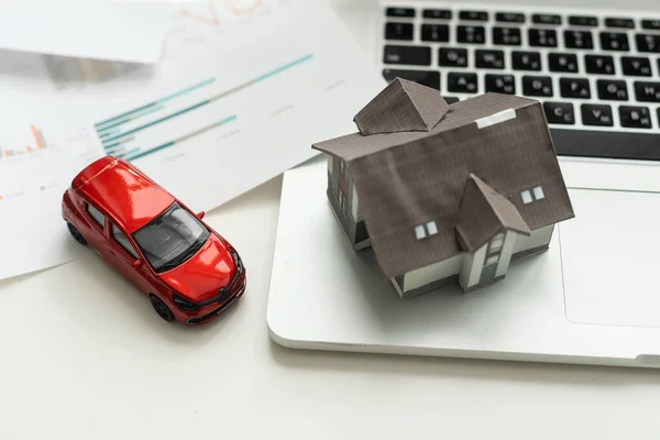 Car and house. Miniature car and house on white background. High quality photo