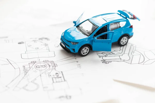 Toy car, black ink pen and documents on table. Toy sports car and pen on the form for the inspection of the car. Car inspection concept. High quality photo