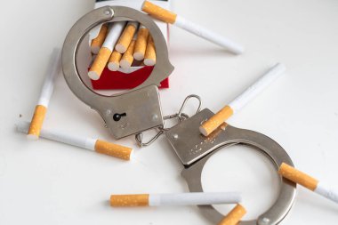 Beyaz zeminde kelepçeli bir paket sigara. Tütün günü konsepti yok. Yüksek kalite fotoğraf