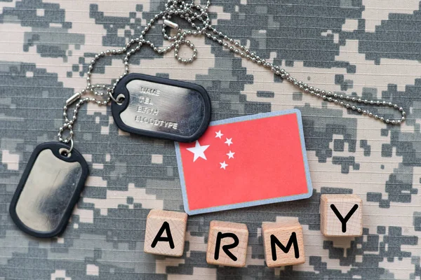 army blank, dog tag with flag of russia and china on the khaki texture background. military concept. High quality photo