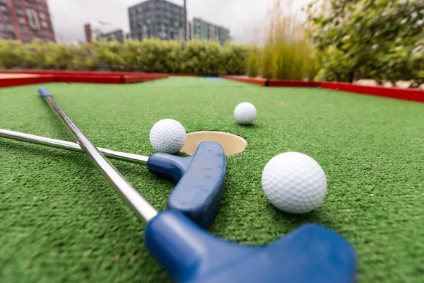 Close up, Old golf balls and putter on artificial grass for practice. High quality photo
