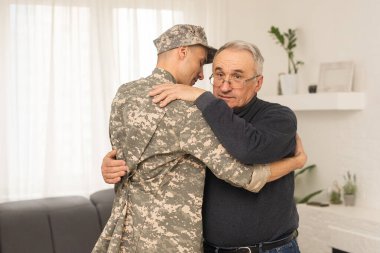 Portrait of army man with parents, elderly father and military son