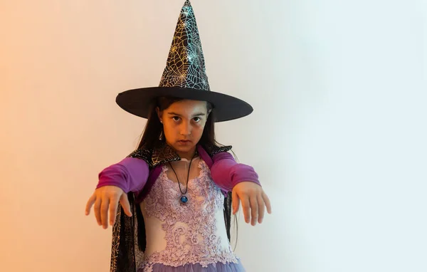 stock image teenage girl in a witch costume, happy halloween holiday