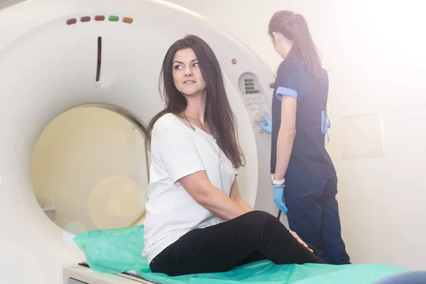 Doctor doing computed tomography for female patient stock photo. Medicine diagnostic concept.