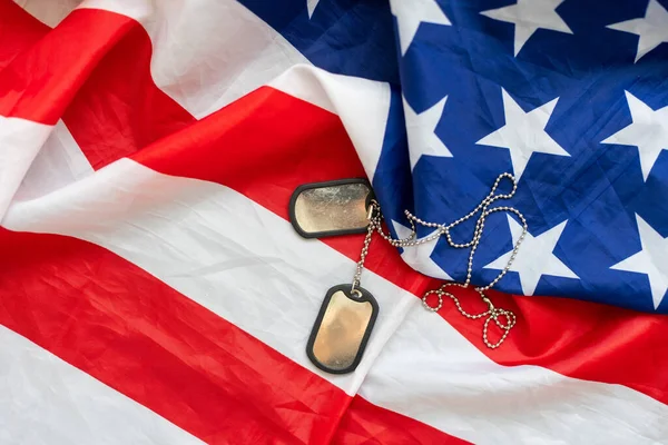 military dog tags on American flag with embroidered stars. High quality photo