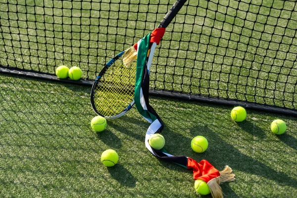 High angle view of tennis ball with racket by net on court. High quality photo