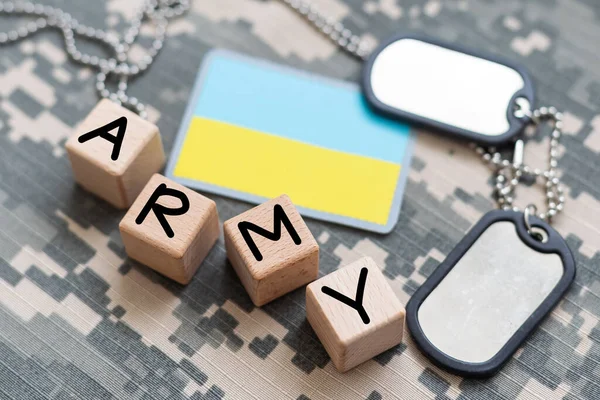 Military patch and bullets on pixel Ukrainian camouflage, closeup. High quality photo