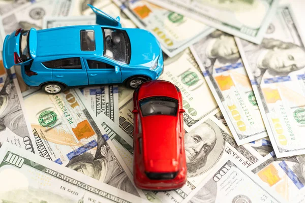 red and blue cars with dollar. High quality photo