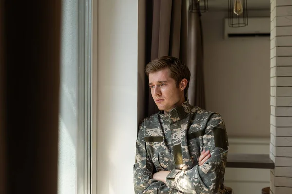 Portrait of middle aged sad, desperate military man looking thoughtful at camera during therapy session. Disabled soldier suffering from depression psychological trauma. PTSD concept. Horizontal shot.
