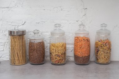 organization of food storage in the kitchen, transparent reusable jars for cereals and pasta, zero waste pantry.
