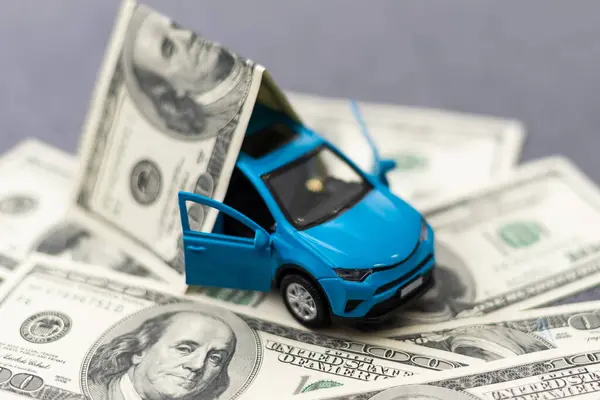 concept of insurance, credit and car purchases, car loan, Auto dealership and rental, new car buy. toy car dollar bill. High quality photo