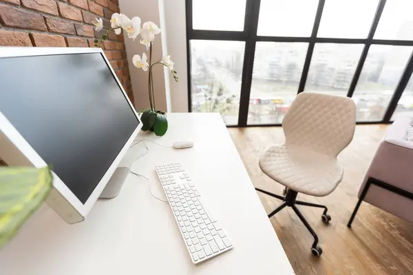 Loft workspace concept. white screen modern desktop computer and books, minimal stuff on desk