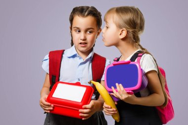 School kids eating healthy food together. schoolchildren with lunch boxes.