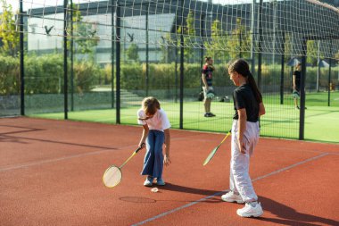 Futbol sahasında badminton raketleri olan iki kız. Yüksek kalite fotoğraf