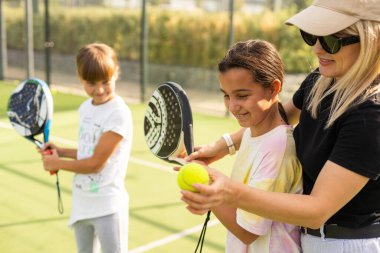 Amigo koç, her ikisi de tenis kortunda dururken çocuğa tenis oynamayı öğretiyor. Yüksek kalite fotoğraf